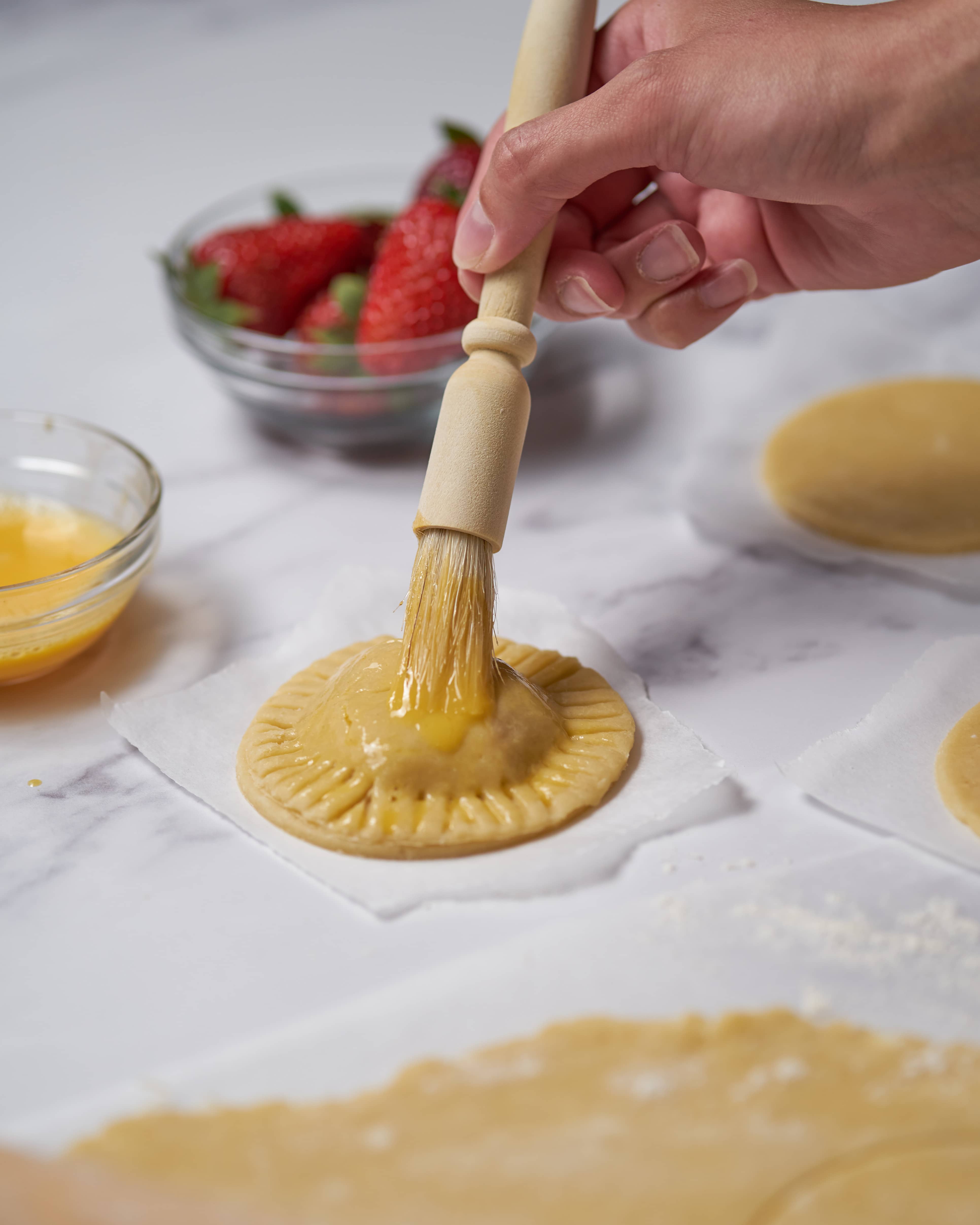 Brushing pie crust with egg wash